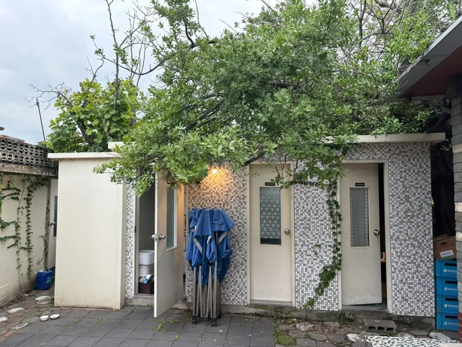 Restroom building beside a tree
