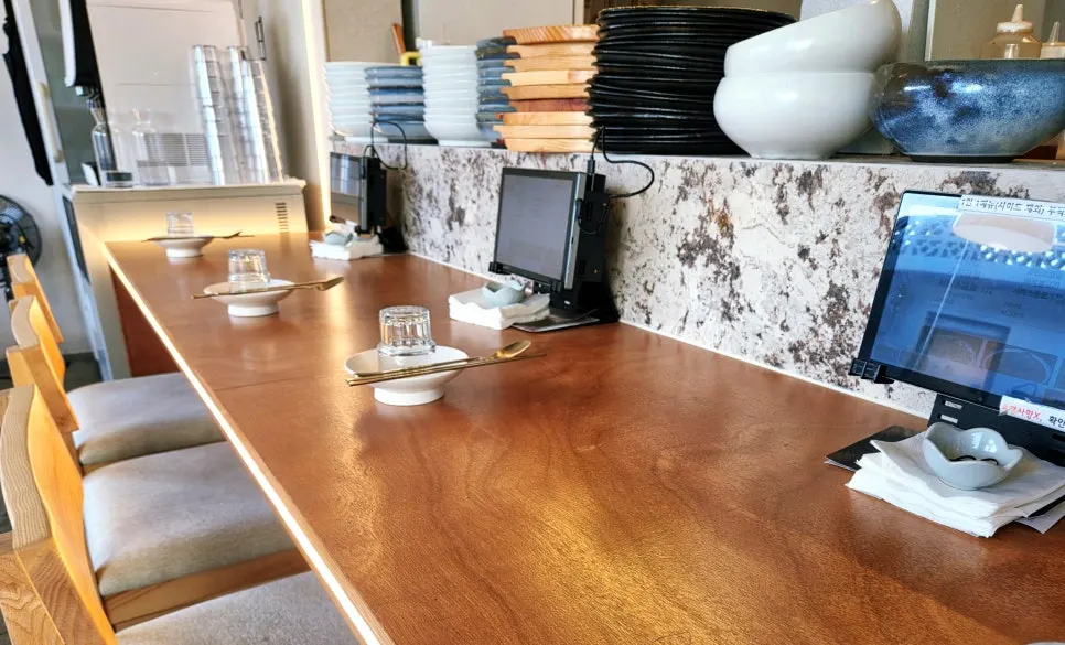 Bar seating in front of the open kitchen