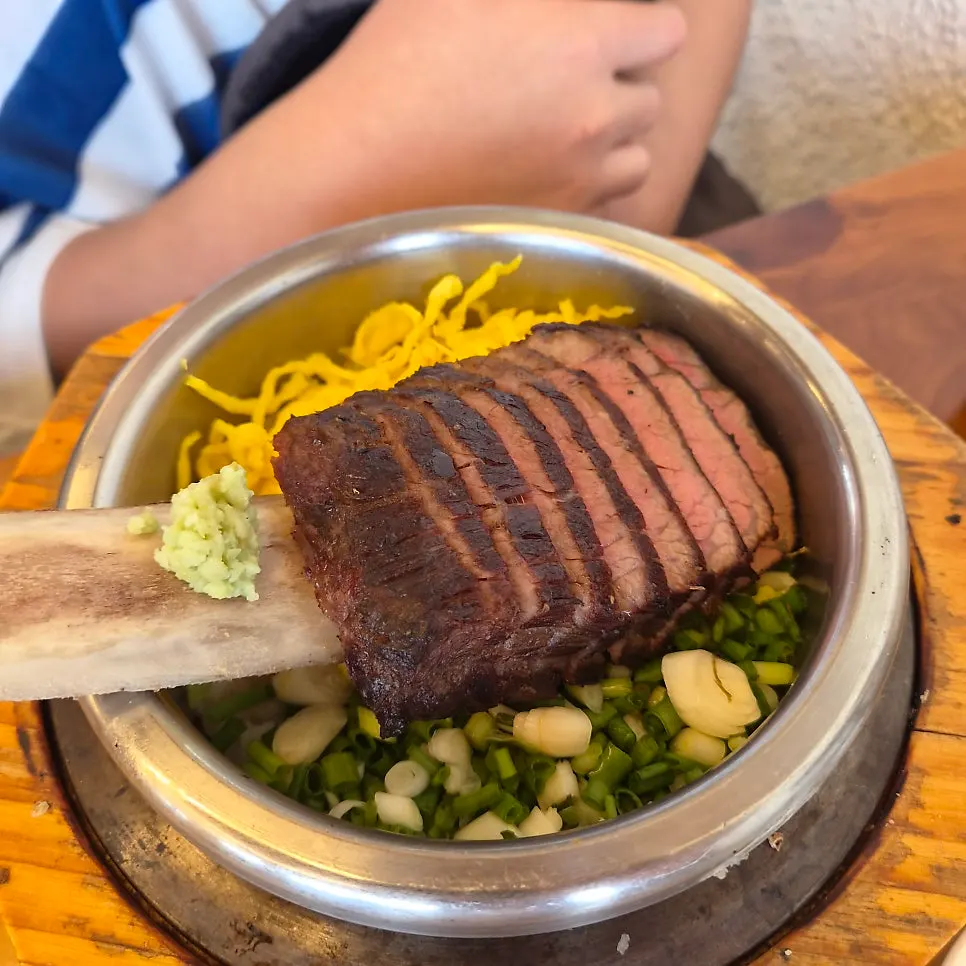 Short rib hot pot rice with a whole rib piled on top
