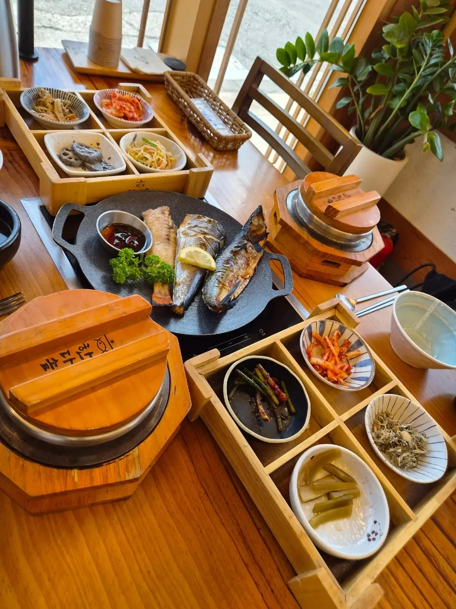 Neatly served grilled fish and pot-rice meal