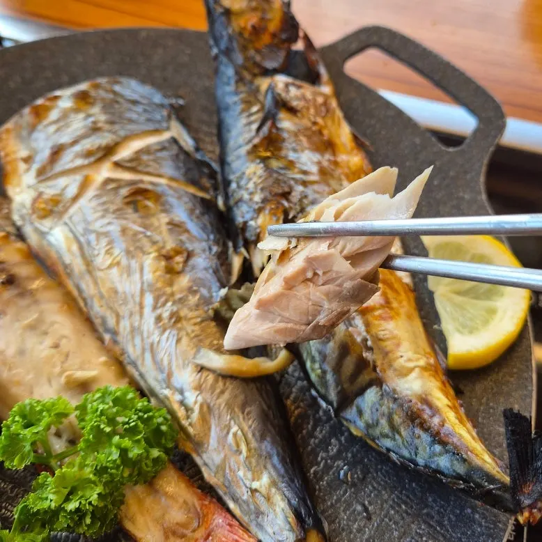 Pulling mackerel flesh from the bone