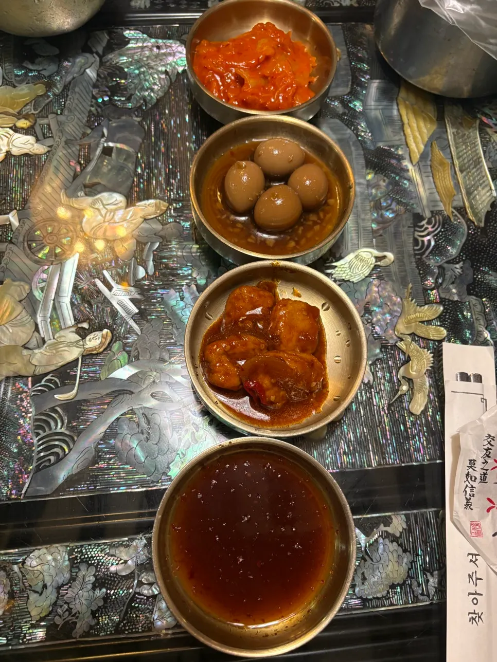 Three basic side dishes including stir-fried kimchi and soy-braised quail eggs