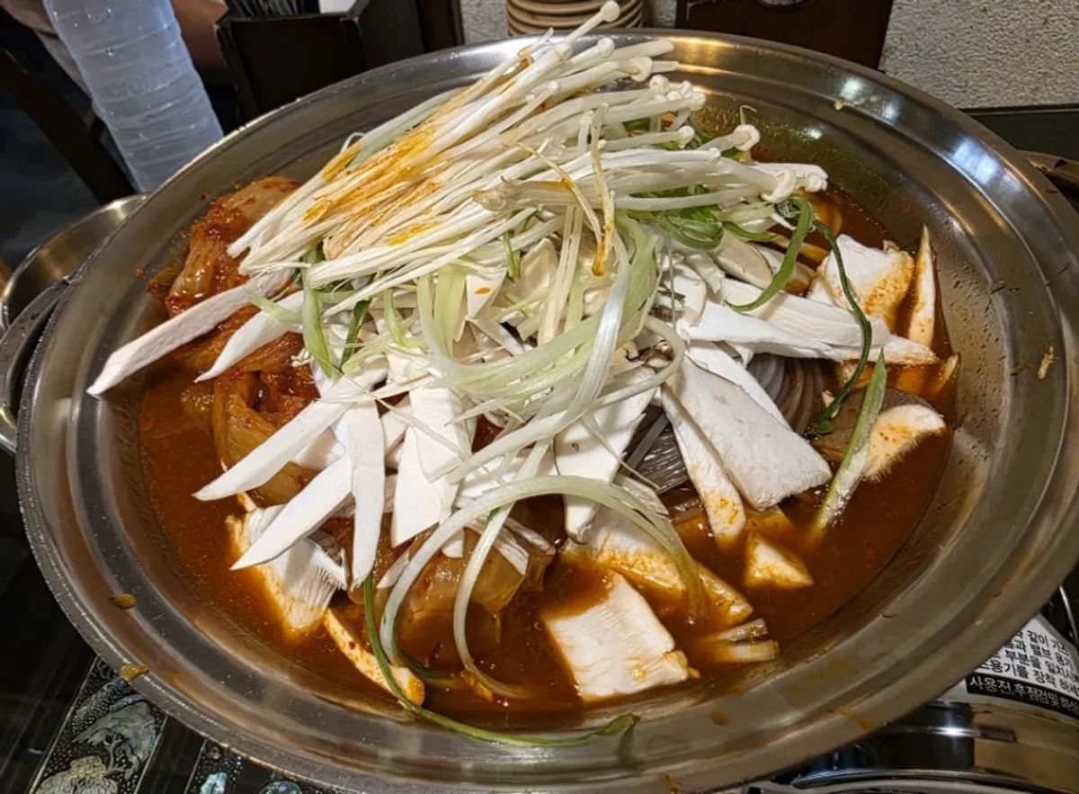 Table setup with aged-jar ripe kimchi rib stew for two