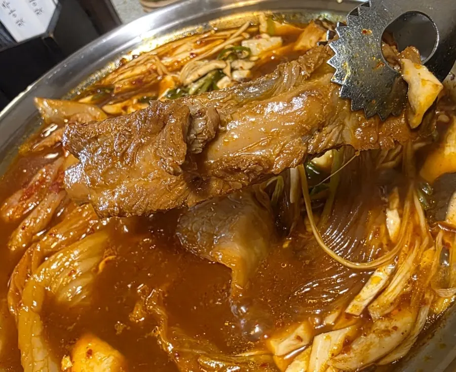 Sauce-soaked glass noodles inside the rib stew