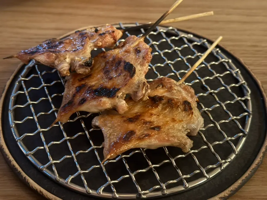 Skewer of grilled chicken thigh meat and green onion