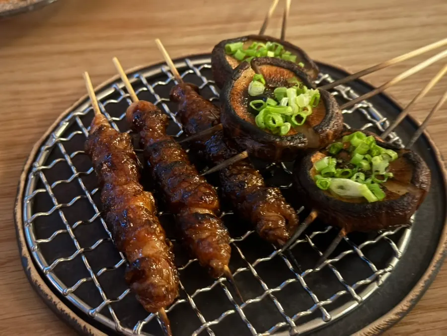 Grilled chicken wing boned out on the skewer