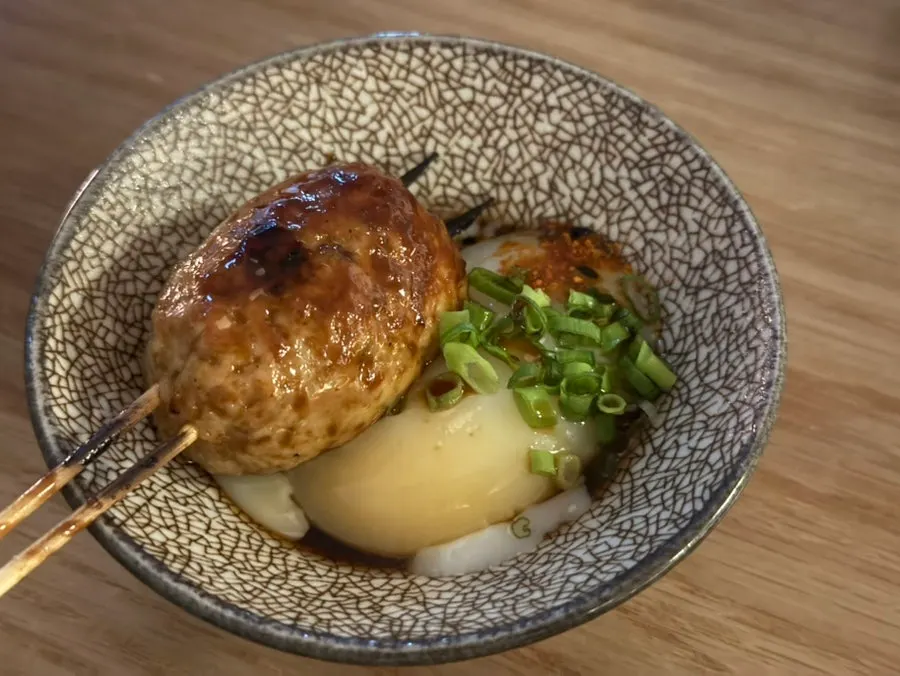 Tsukune chicken meatball skewers with a poached egg
