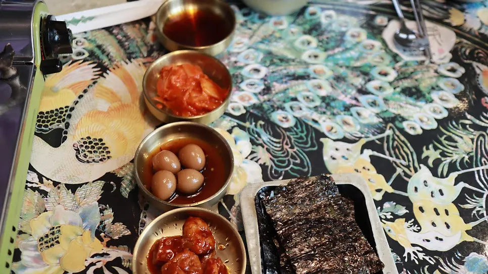 Side dishes fully spread across a mother-of-pearl table