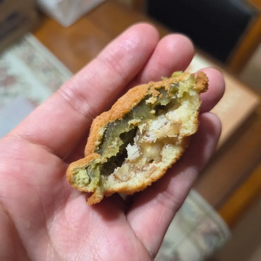 A walnut pastry cut in half showing the whole walnut inside