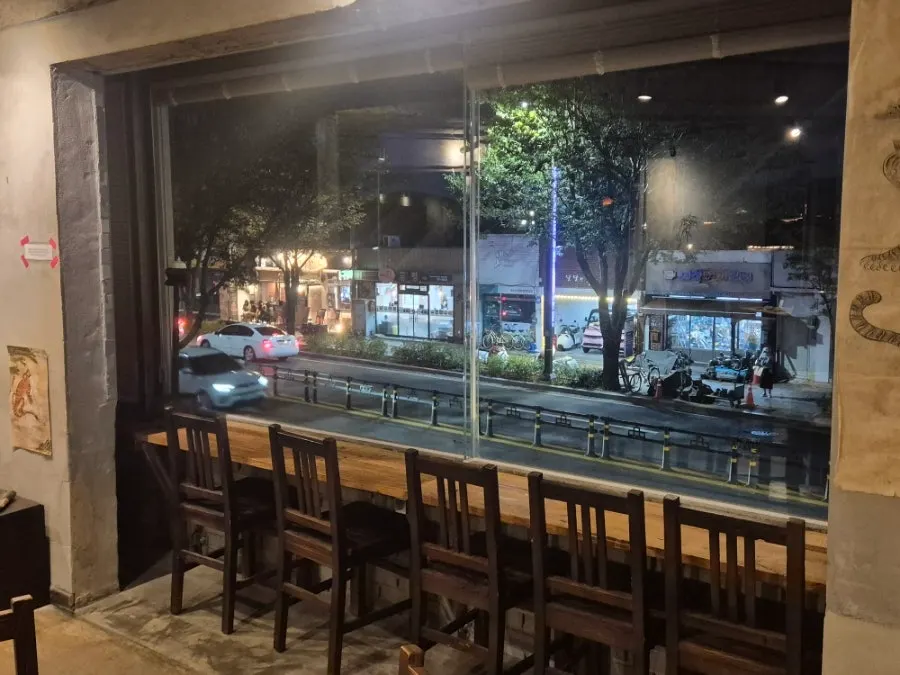Family sitting by the window watching Gyeongju's night view
