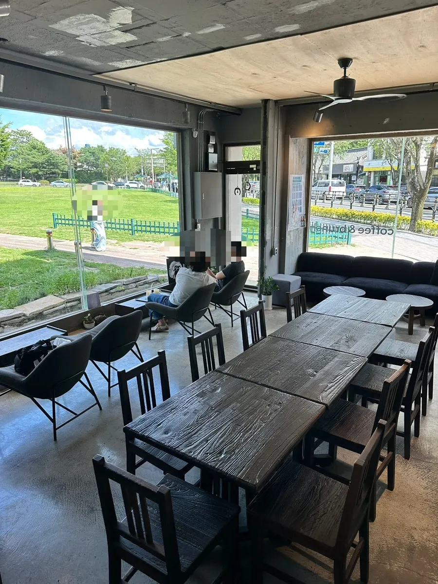 Floor-to-ceiling window seats inside Cafe Bonghwangdang