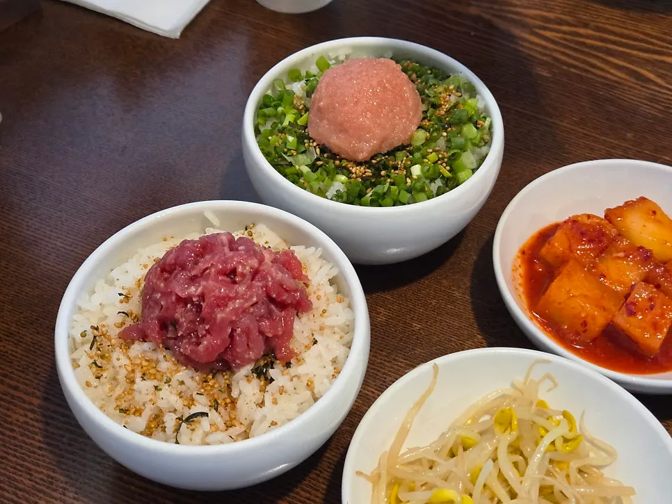 Side dish plates including bean sprouts and diced radish kimchi