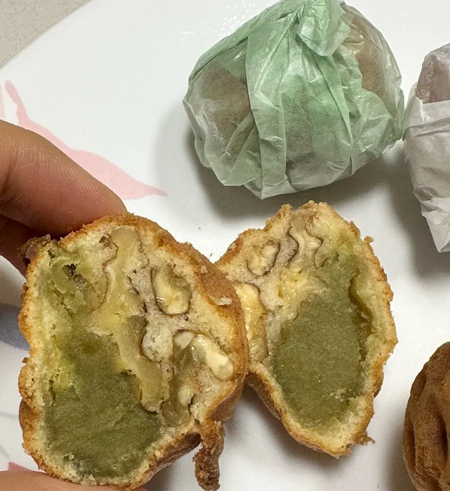 Inside of Buja Hodu walnut pastry showing paste and whole walnut