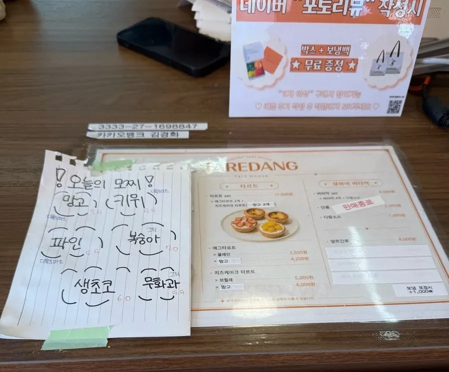 Sign listing Tareudang's fresh fruit mochi and tart menu