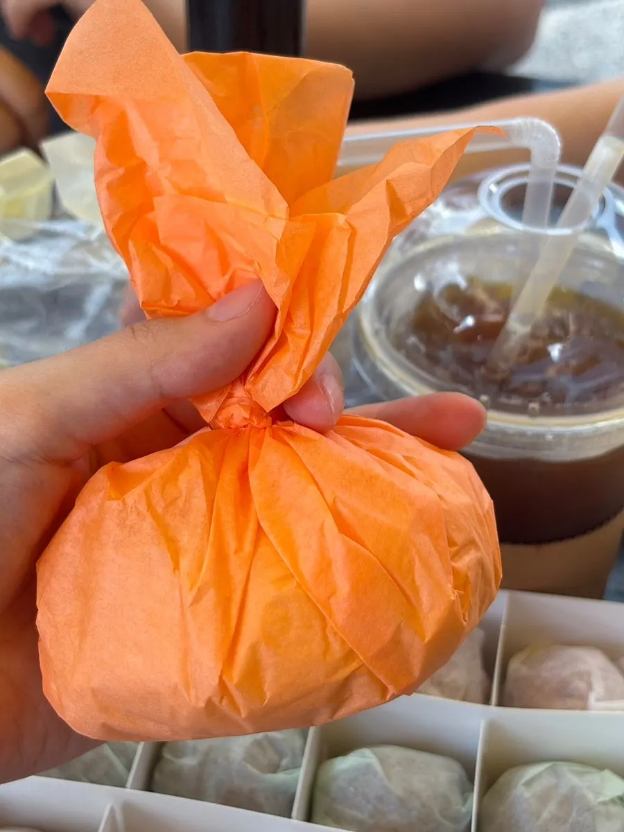 Three fresh fruit mochi wrapped in hanji-style paper