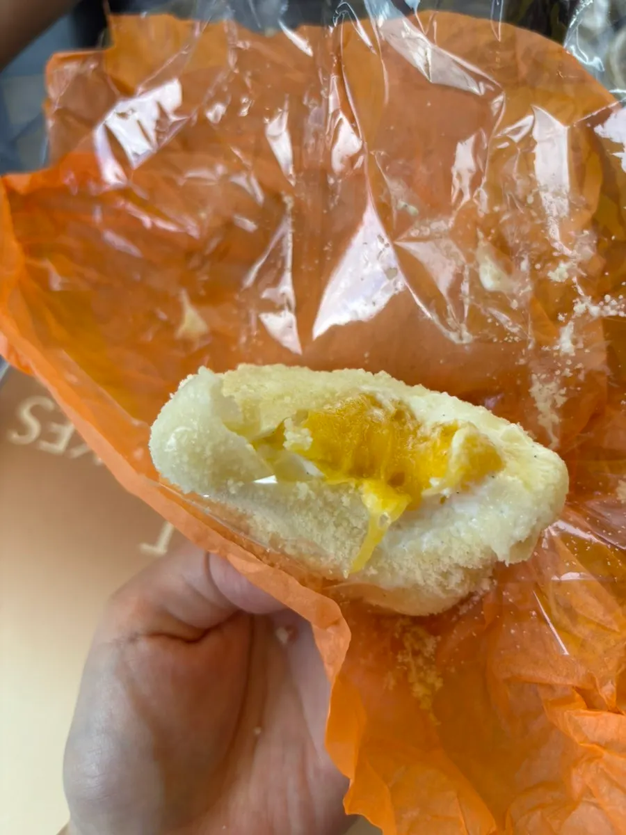 A Tareudang fresh fruit mochi held in hand