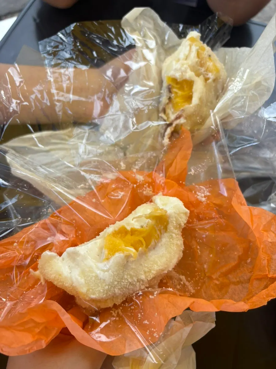 Inside of the mochi showing diplomat cream and mango