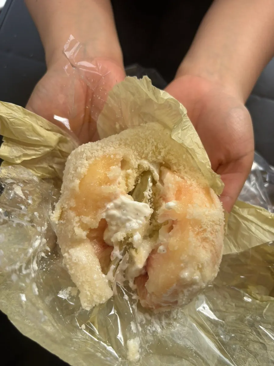 Cross-section of a bitten Greek yogurt peach mochi