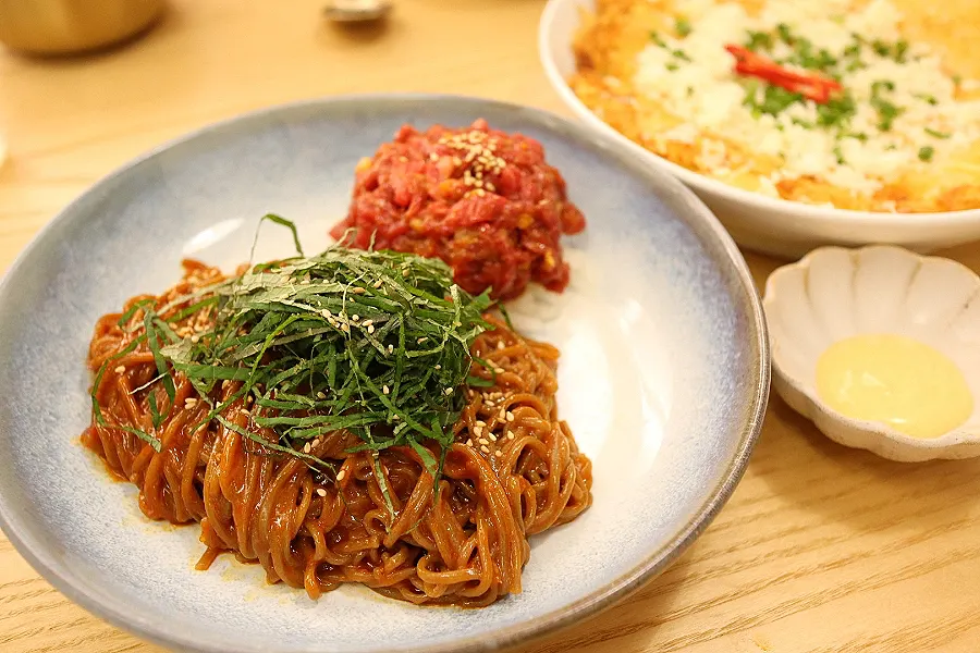 A bowl of hanwoo yukhoe bibim buckwheat noodles