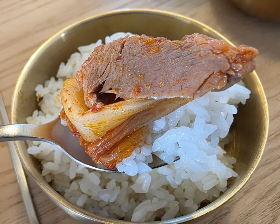 A bite combining kimchi and meat together