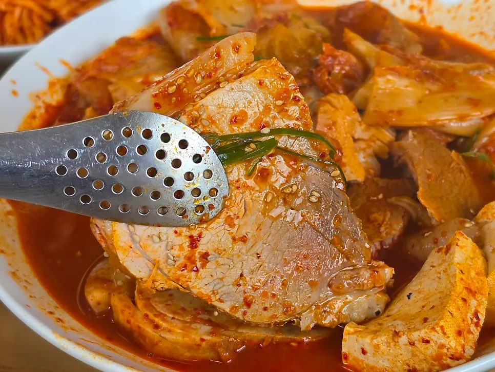 Tender pork pulling apart easily in the kimchi jjim