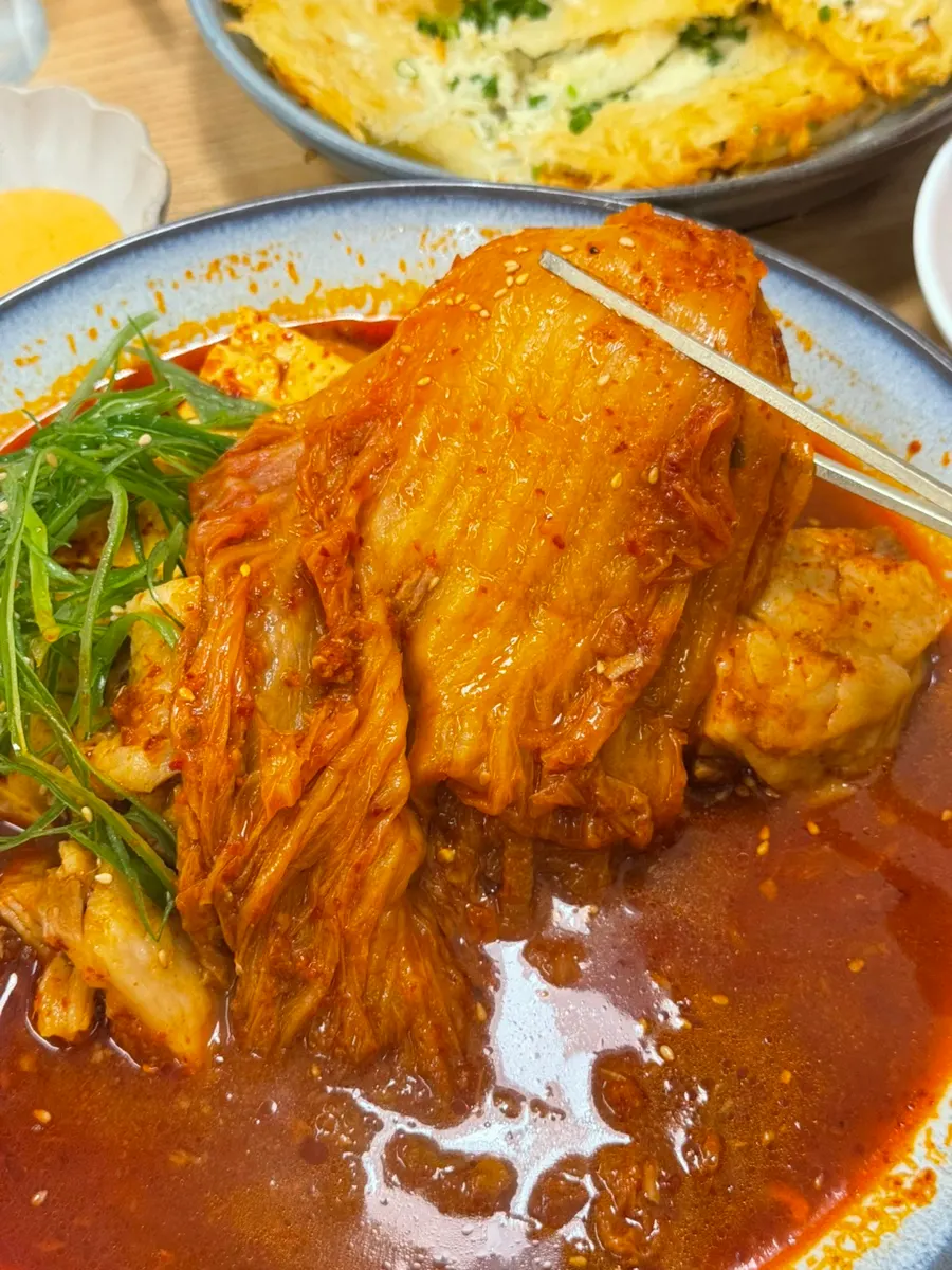 Goyu's pork kimchijjim for two topped with scallion strips