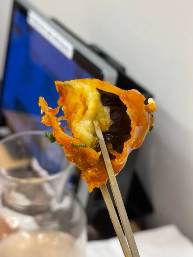 A crispy fried piece of eggplant gangjeong