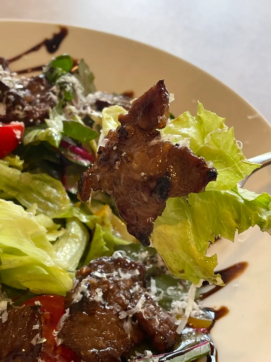 Midam Kitchen's beef salad topped with house-marinated grilled beef