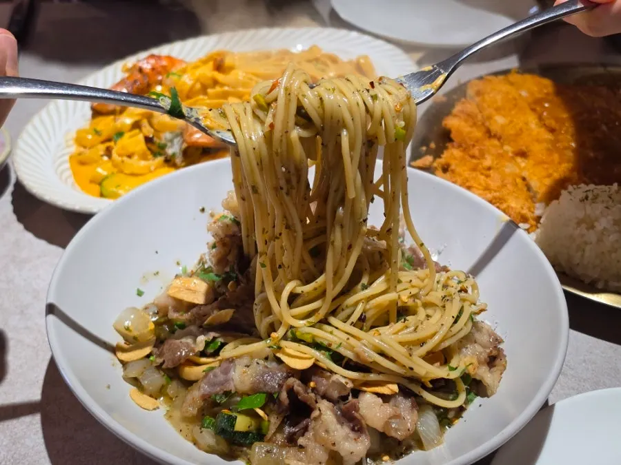 Beef brisket oil pasta with garlic scapes and zucchini