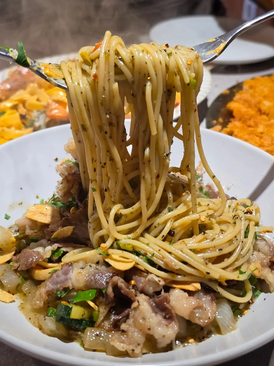 A bite of beef brisket and noodles together