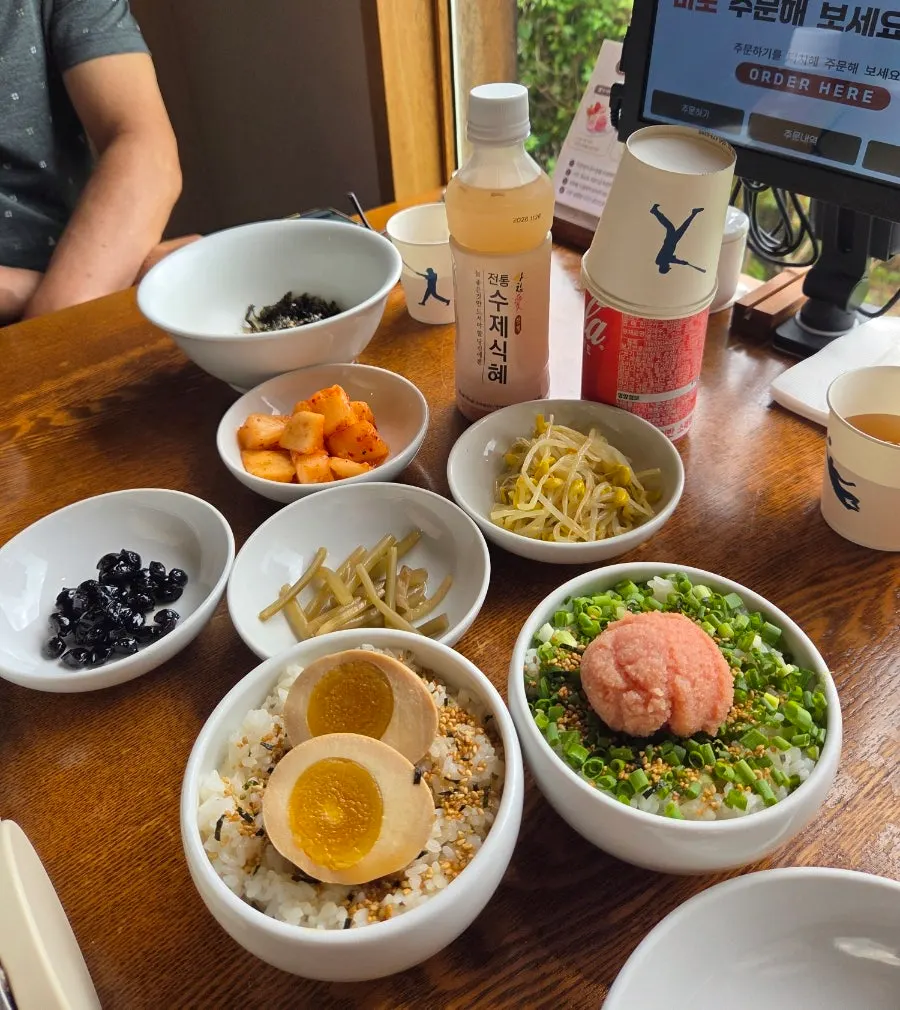 Table set with basic side dishes, egg rice, and pollock roe rice