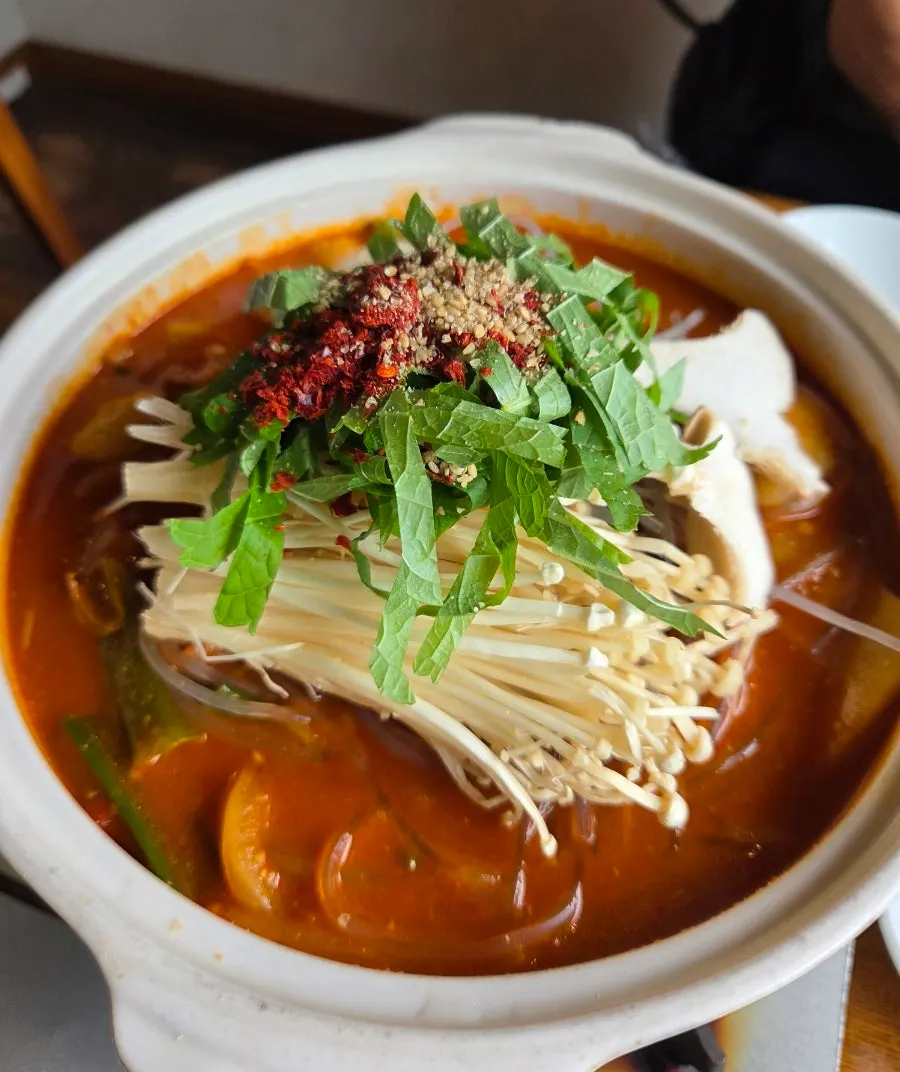 Beef tripe hot pot broth and ingredients simmering