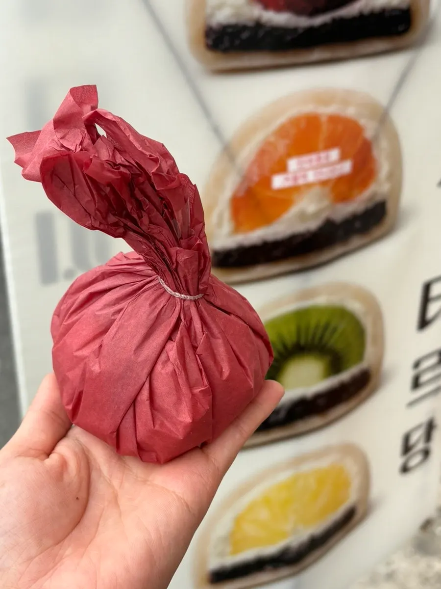 Tareudang fruit mochi held up to show its size