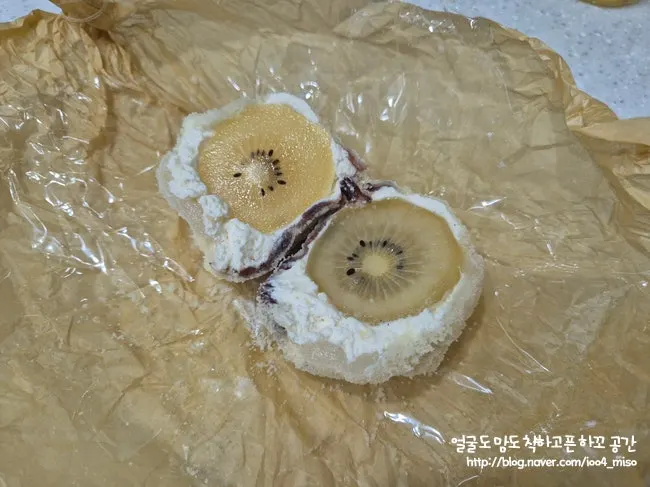 Whole kiwi with cream and red bean visible inside the mochi