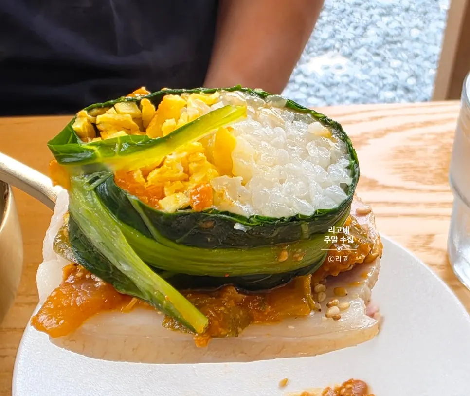 Kale ssam topped with cold jeyuk and ganjang
