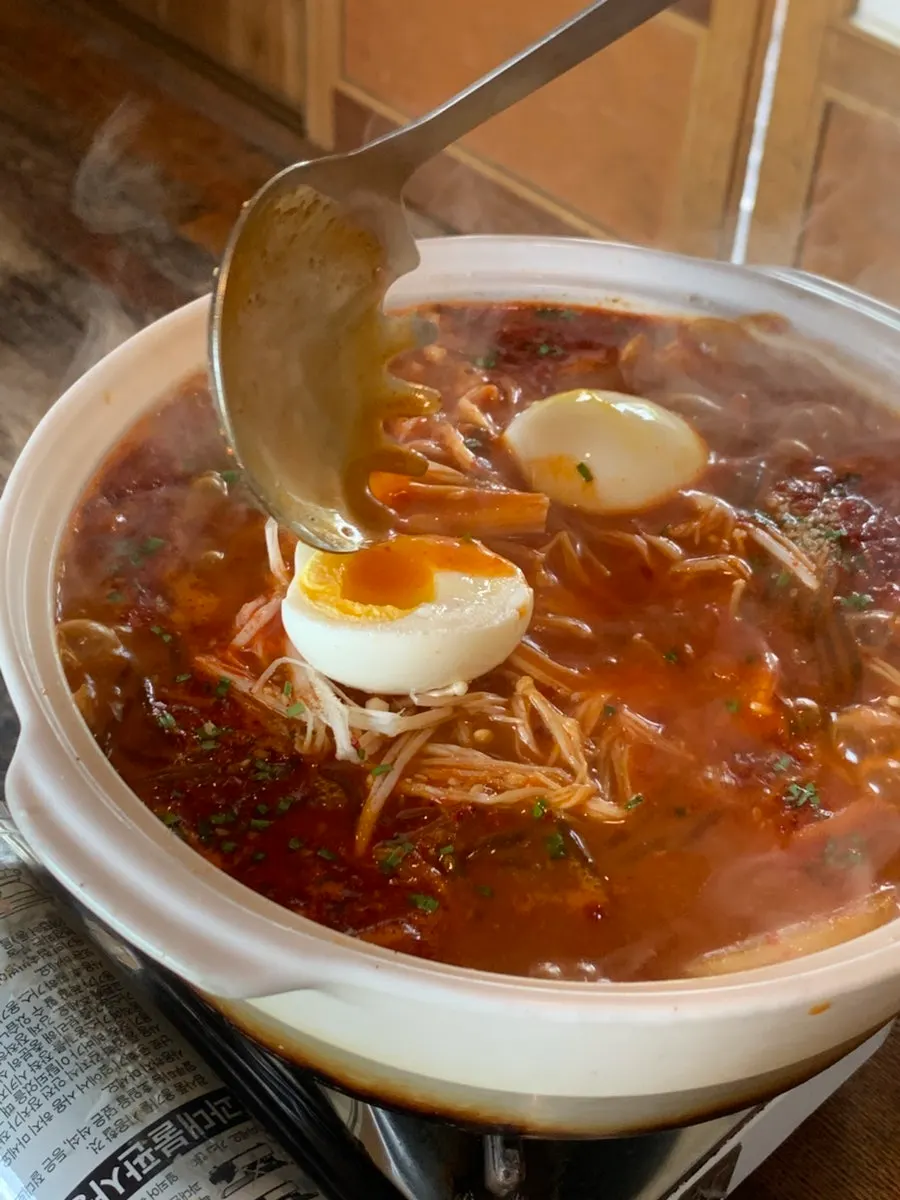 Rich dakbokkeumtang broth with chicken