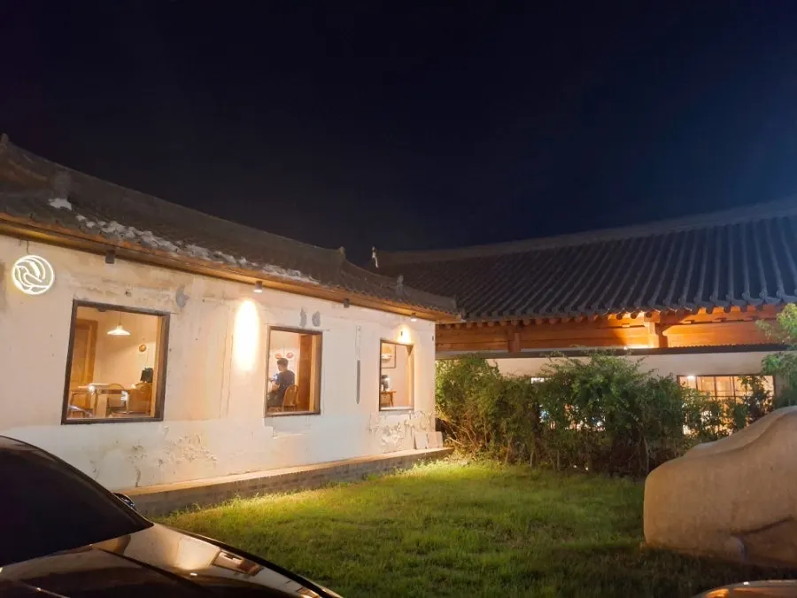 Dongyang Baekban's hanok exterior lit up in the evening