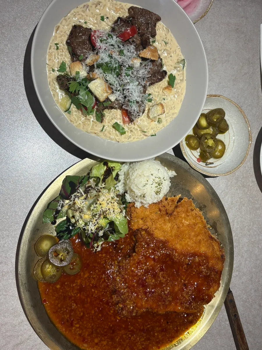 Table setting with beef risotto and kkanpung pork cutlet