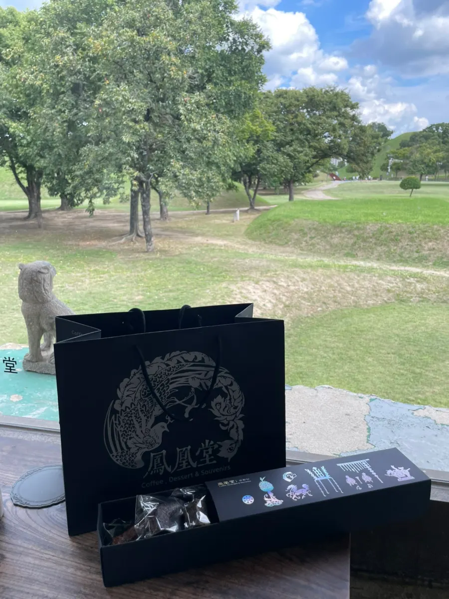 Two drinks by a window with a tomb view