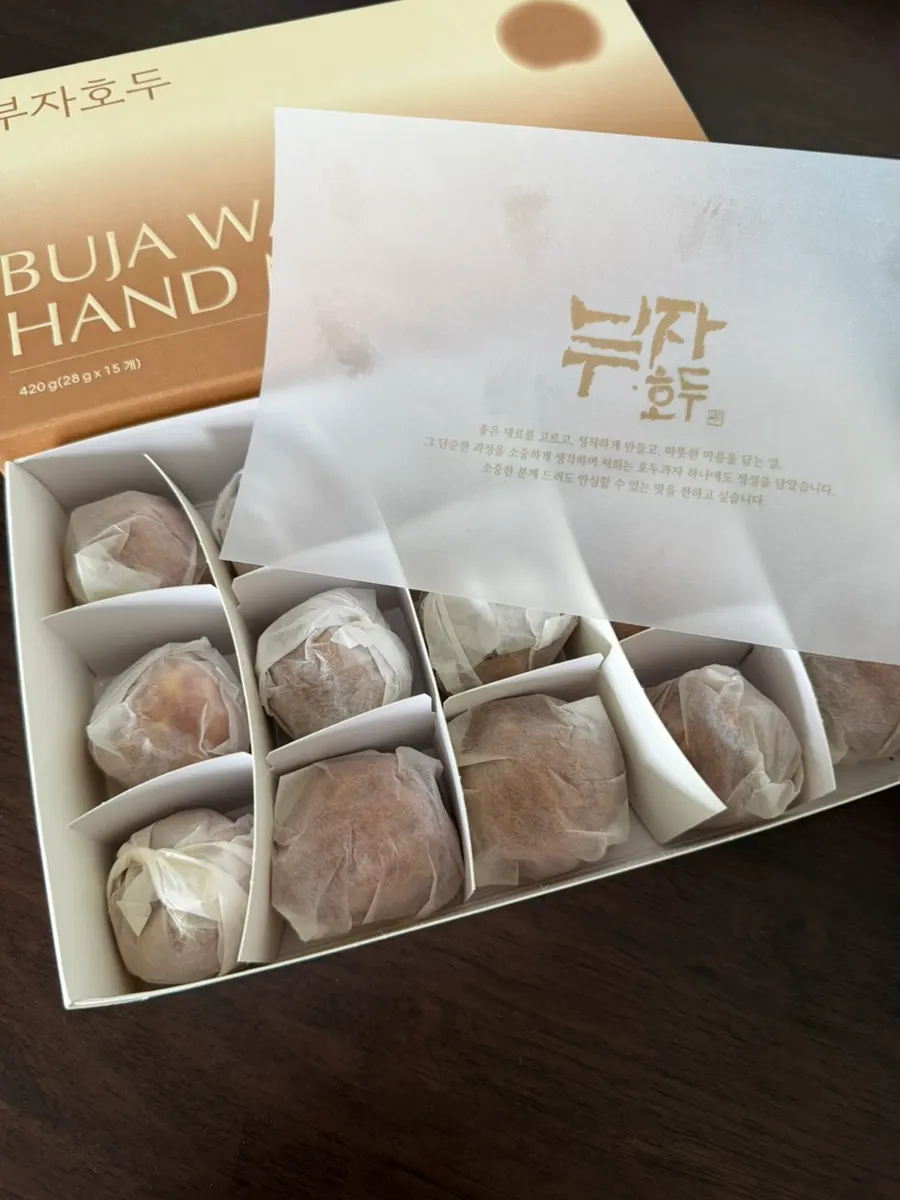 15 walnut pastries neatly arranged inside the box