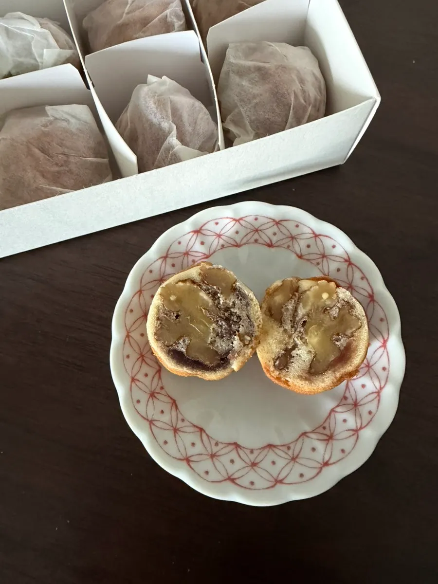 A single Buja Hodu walnut pastry held in hand