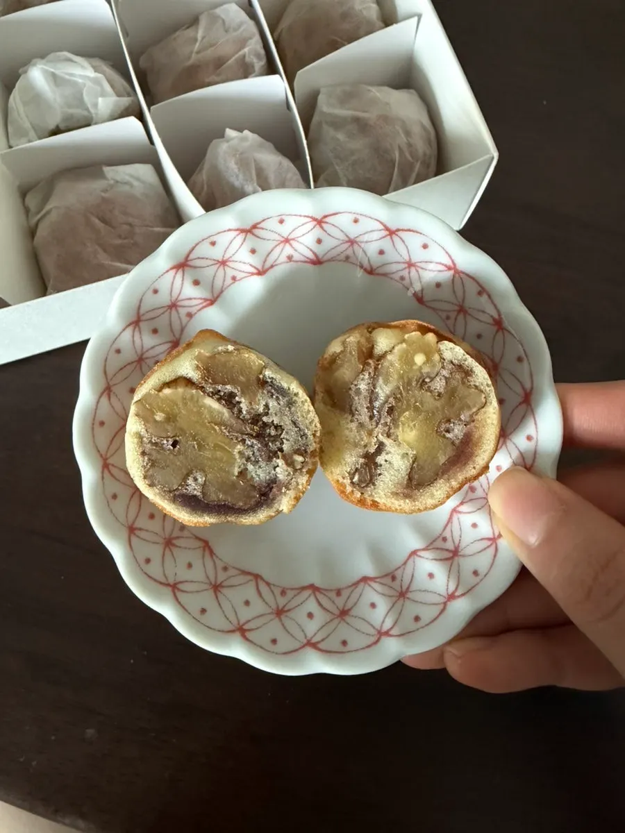 Cross-section of a walnut pastry showing a big walnut piece