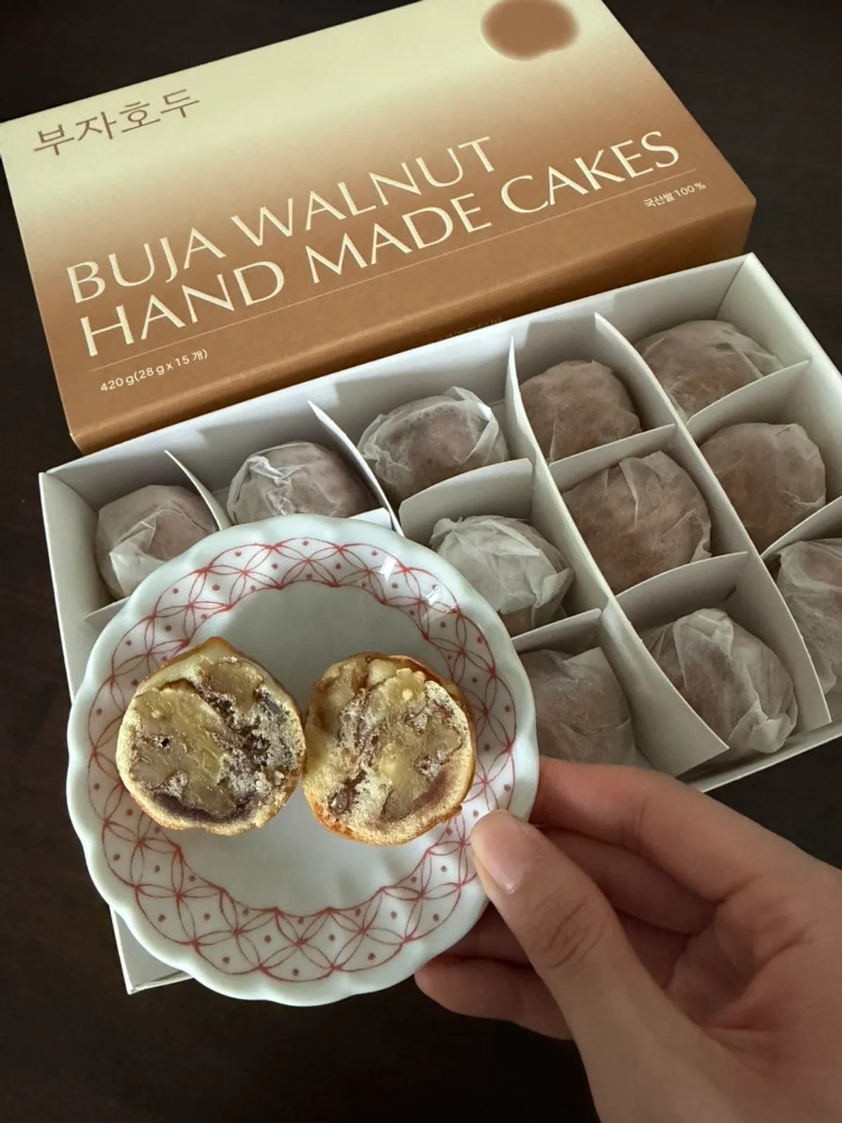 Close-up of a walnut pastry cross-section packed with whole walnut between red bean paste