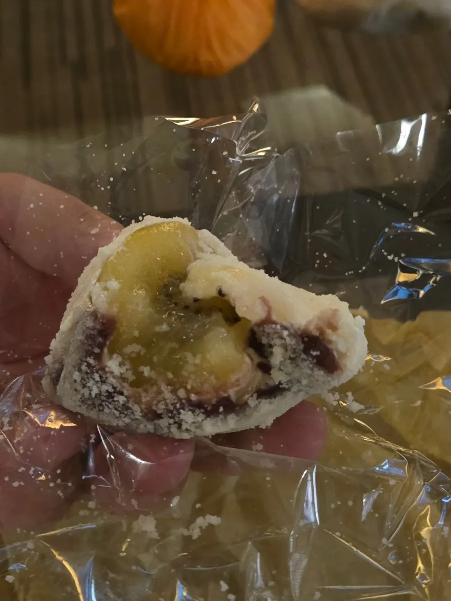 Gold kiwi mochi with a bite taken out