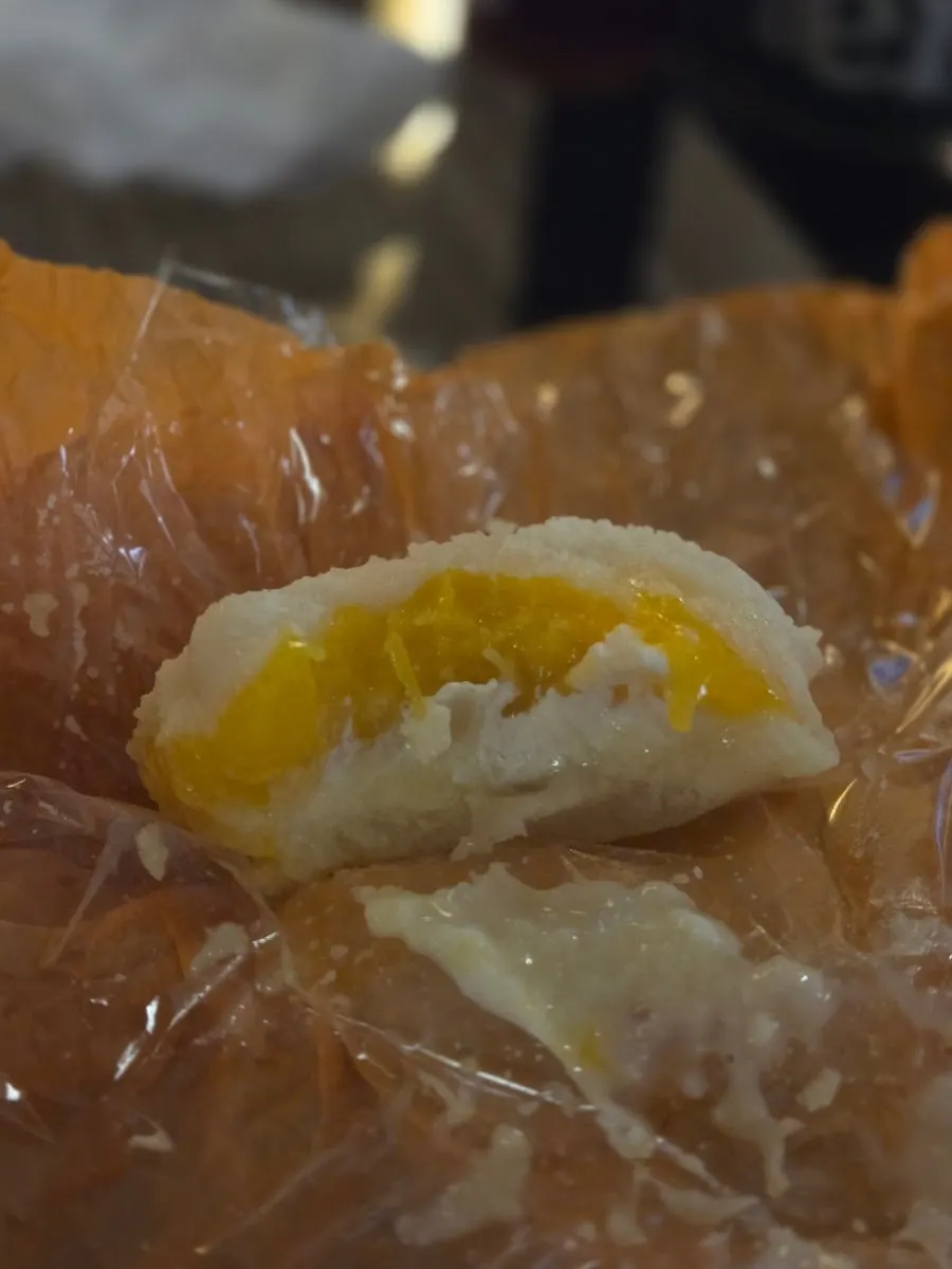 Cross-section of mango yogurt mochi showing whole mango