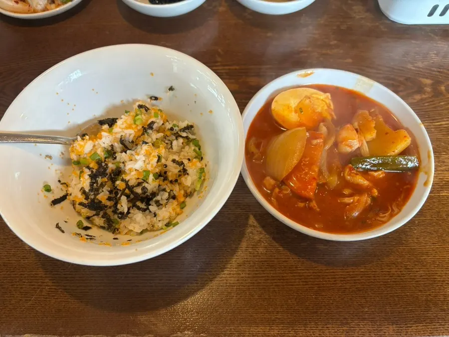Pot of sumi dakbokkeumtang topped with a soft-boiled egg