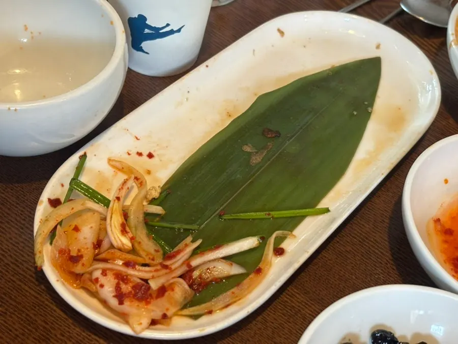 Empty dakbokkeumtang pot and rice bowl, scraped clean