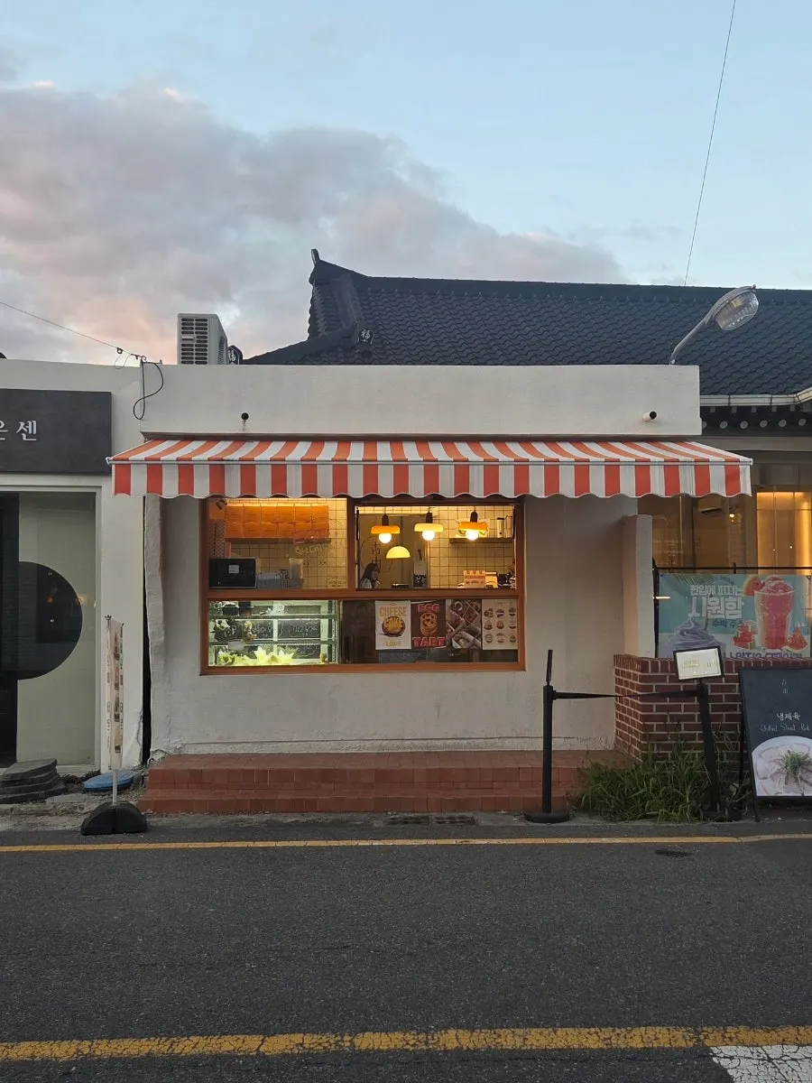 Tareudang storefront on Hwangnidang-gil under the evening sky