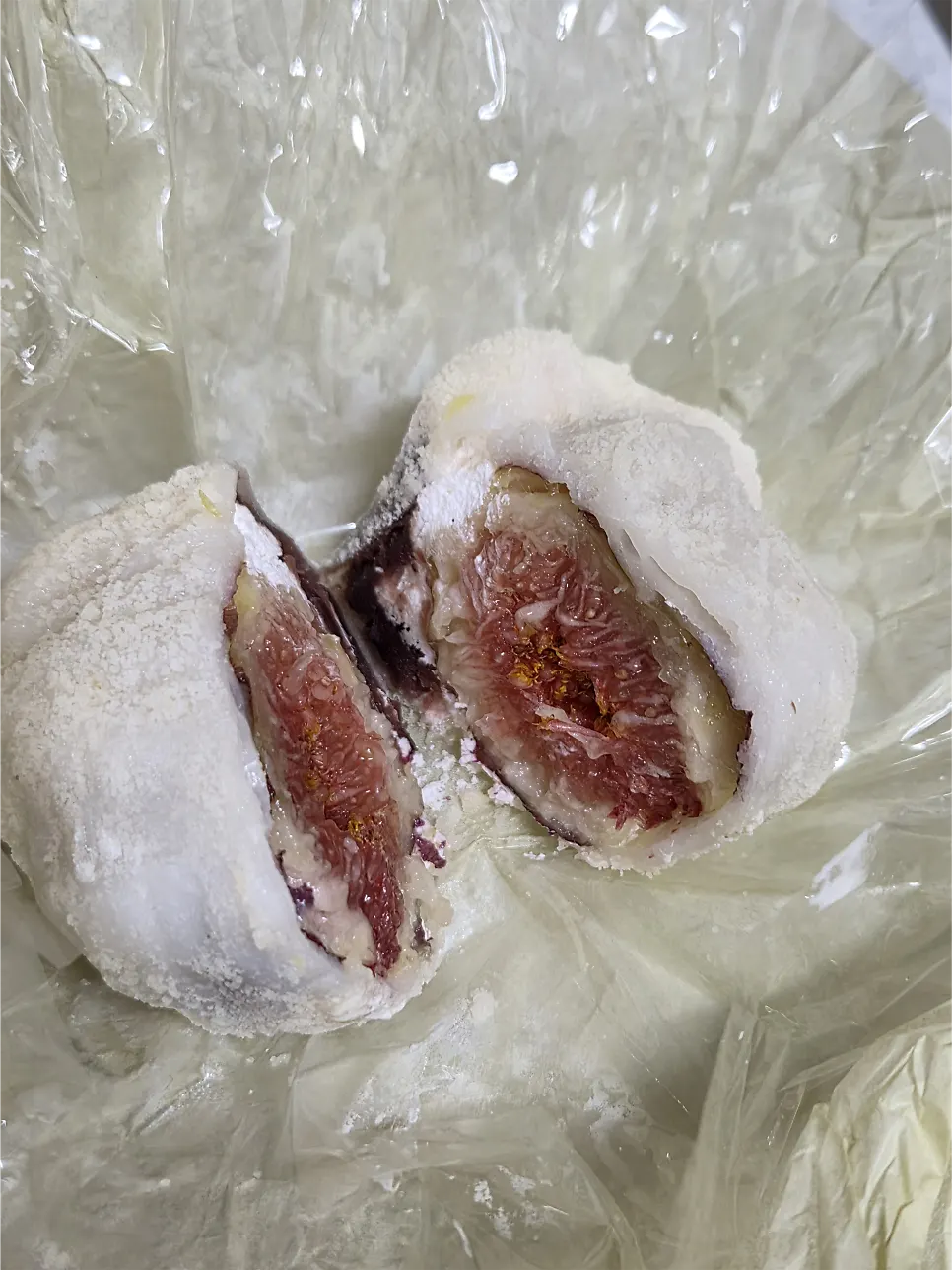 Cross-section showing red bean and whipped cream inside a fruit mochi