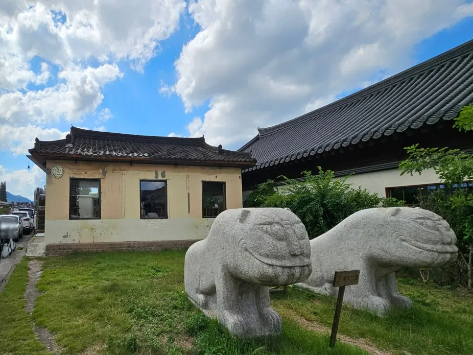 Hanok exterior and stone statues at Dongyang Baekban